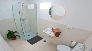 a bathroom with a shower and a toilet and a sink at Apartamento, Arena, Primera linea Mar, sea views in Playa Honda +29 photos