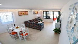 a living room with a couch and a table at Apartamento, Arena, Primera linea Mar, sea views in Playa Honda