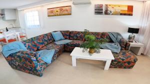 a living room with a couch and a table at Apartamento, Arena, Primera linea Mar, sea views in Playa Honda