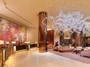 a large living room with a large chandelier at Fairmont Singapore in Singapore