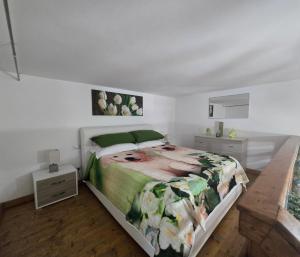 a bedroom with a large bed with a green blanket at La Casa di Teo Sorrento Coast in Sant'Agnello