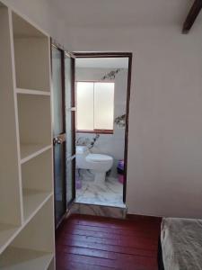 a bathroom with a toilet and a sink at Hospedaje Apu San Isidro in Urubamba +51 photos