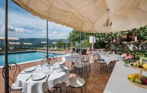 a restaurant with tables and chairs and a pool at Gorgeous Home In Rivodutri in Apoleggia