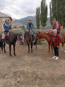 a group of people riding horses and a girl at Kf guest house 2 in Shabdan +7 photos