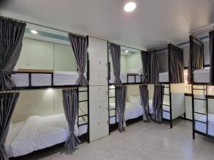 a group of bunk beds in a room at KL's Coffee & Hostel in Pakse