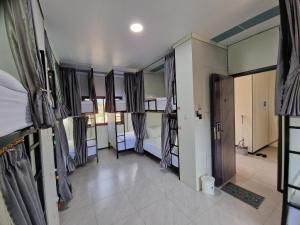 a room with two bunk beds and a hallway at KL's Coffee & Hostel in Pakse