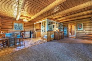 a dining room and kitchen in a log cabin at Rowland Log Cabin in Lyle