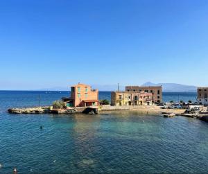 a small island in the middle of a body of water at Al Baglio di Sant'Elia in Santa Flavia +9 photos