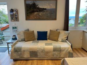 a bedroom with a bed and a painting on the wall at Gîtes du Fort in Collonges