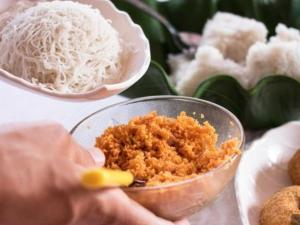 a person holding a bowl of rice and other foods at Golden Heavens kengalla in Kandy