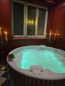 a jacuzzi tub in a room with candles at Elisabeta Suite - Eternal Romance with Balneo XL in Chamalières +17 photos