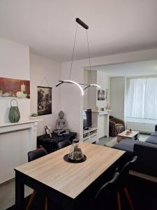 a living room with a table and a couch at Sandrashuis in Zulte +9 photos