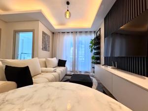 a living room with a large bed and a couch at Modern Luxury 1BR in Nairobi +21 photos