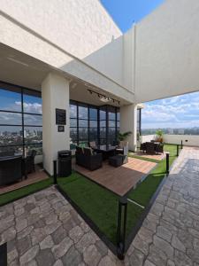 a large white building with a patio and grass at Modern Luxury 1BR in Nairobi