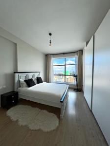 a bedroom with a large bed and a large window at Modern Luxury 1BR in Nairobi