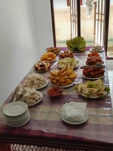 a table with plates of food on top of it at Golden Heavens kengalla in Kandy +11 photos