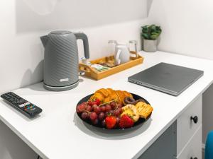 a bowl of fruit and waffles on a kitchen counter at Hilltop Apartment 6 - Uk50598 in Earl Shilton