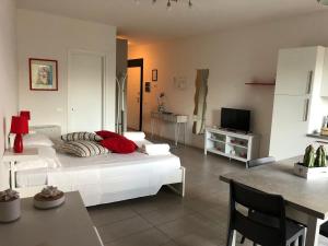 a bedroom with a bed and a table and a television at Siena, a due passi dal centro, posto auto incluso in Siena