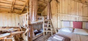 a room with a bunk bed and a ladder at Camping Alsace Les Castors in Burnhaupt-le-Haut