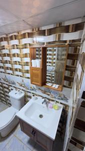 a bathroom with a white sink and a toilet at Desert Island Camp in Wadi Rum +75 photos