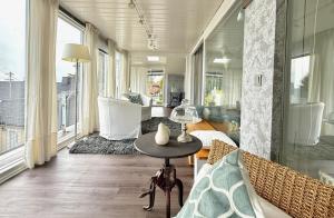 a living room with a table and some windows at Westerwald Hideaway 