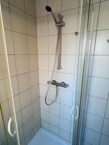 a shower with a shower head in a bathroom at Charmant Studio proche tramway in Strasbourg