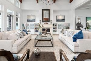 a living room with white furniture and a fireplace at Landing Apartments Charleston - Summerville in Cloverleaf Mobile Home Park