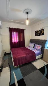 Ένα ή περισσότερα κρεβάτια σε δωμάτιο στο Studio Meublé Bonamoussadi