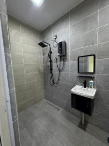 a bathroom with a shower and a sink at Habib Roomstay in Jeli