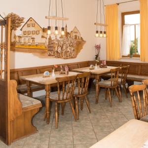 a dining room with wooden tables and chairs at Dorfschänke Kreuz in Landensberg