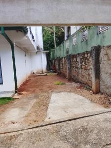 an empty room with a building with a wall at Golden Heavens kengalla in Kandy