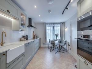 a kitchen with a table and chairs in it at Sea Beet - Uk49245 in Whitstable