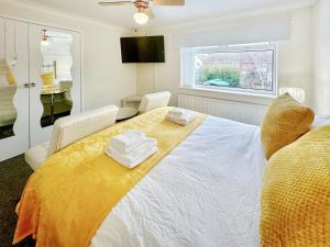 a bedroom with a bed with two towels on it at Sunrise Villa in Clacton-on-Sea