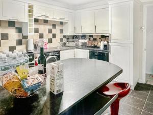 a kitchen with a table with a bottle of wine at Sunrise Villa in Clacton-on-Sea