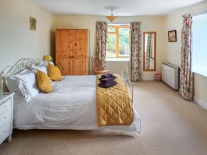a bedroom with a large bed and a table at Erw Goed Old Barn in Arthog