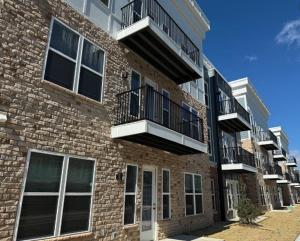 a brick building with balconies on the side of it at Landing Amazing 2BD Gym in Fortville