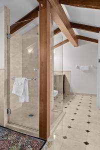 a bathroom with a shower with a glass door at Hotel Manoir D'Auteuil in Quebec City +157 photos
