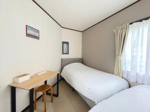 Postel nebo postele na pokoji v ubytování ango kawaguchiko1