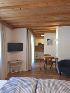 a bedroom with a bed and a table and a dining room at Piz Buin in Kappl