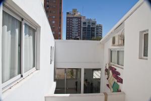 an alleyway between two buildings with a city in the background at Link Cordoba Hostel in Córdoba