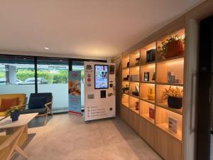 a room with a room with a chair and a window at Chic Vay Central Pattaya Condo in Pattaya North