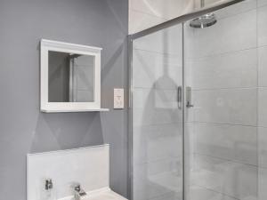 een badkamer met een douche met wastafel en spiegel bij Oak - Uk50462 in Alvington +4 foto's