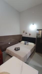 a hotel room with two beds and a mirror at Studio Home in Jacareí