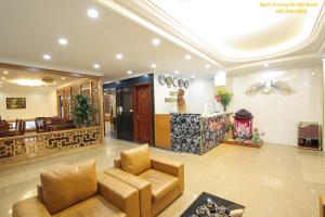 a lobby with a couch and a fire place at Bạch Dương Hotel Hà Nội in Hanoi
