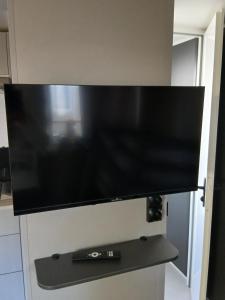 a flat screen tv on a wall in a kitchen at Charmant mobil-home 244 in Narbonne