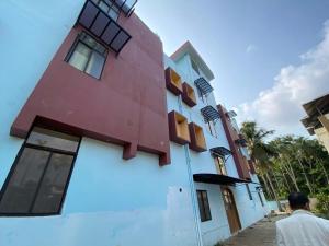 a man standing in front of a building at Hotel O DG College Chelambra in Ferokh
