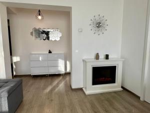 a living room with a couch and a fireplace at Central Vibe in Curtea de Argeş