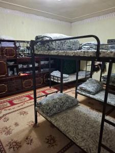 a room with three bunk beds in a room at Lucky hostel in Tashkent