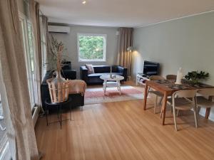 a living room with a couch and a table at Skogsnära boende i Ludvigsborg in Ludvigsborg