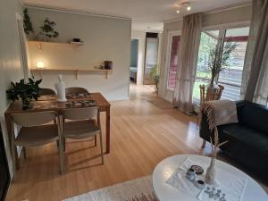 a living room with a table and a couch at Skogsnära boende i Ludvigsborg in Ludvigsborg